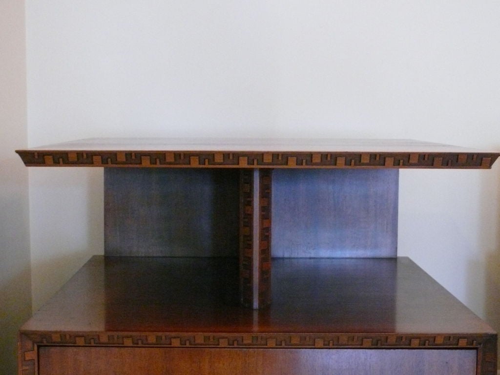Frank Lloyd Wright designed nightstands manufactured by Heritage Henredon with floating top and 2 drawers. Distinct carvings from the Taliesin Line which was named after Frank Lloyd Wright's home in Spring Green, Wisconsin.   Matching cabinet and