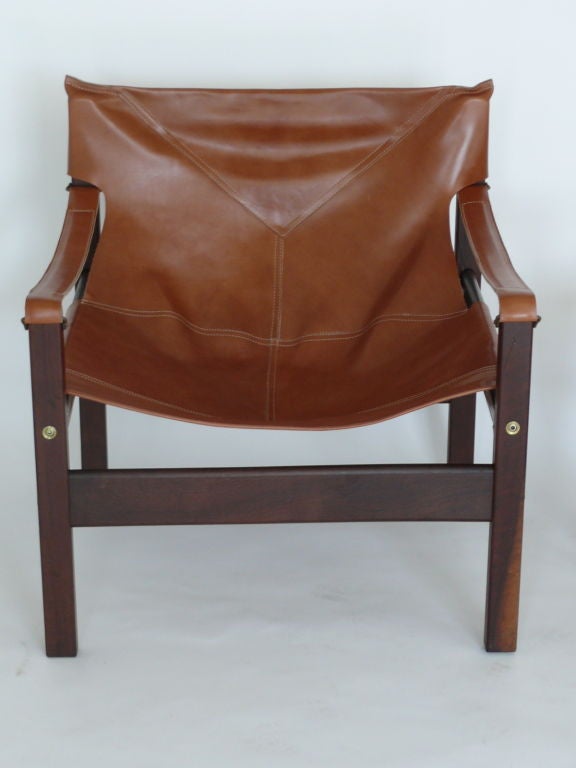 Pair of Sergio Rodriguez inspired leather safari chairs with rosewood and new carmel leather.
