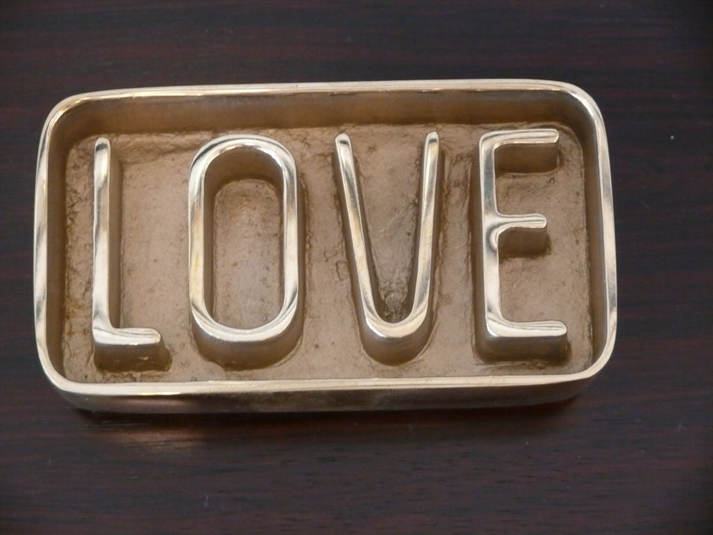Unique paper weight constructed of solid brass with concave letters LOVE.<br />
Hand Made by local artisan and exclusive to Orange.<br />
Great Gift Idea!