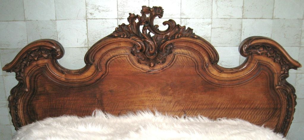 The most magnificent French bed we've had the pleasure of owning, this full size late 19th century carved walnut masterpiece was commissioned for a Parisian family, and was found in it's original location in a grand apartment on the Avenue Foch.