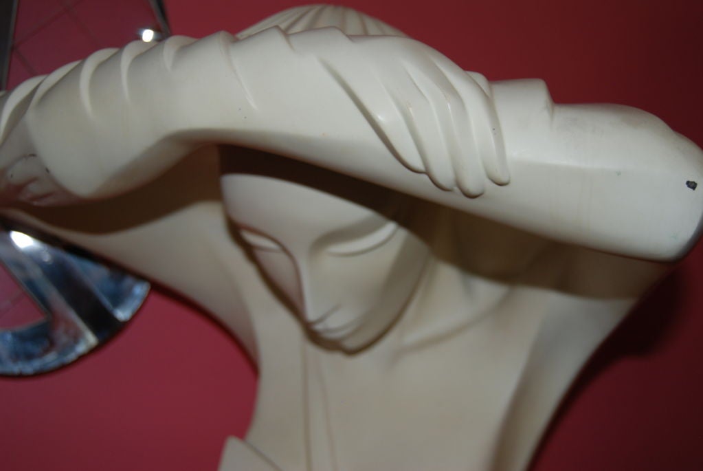 Amazing sculptural signed table lamp designed by Lindsey Balkweill for Lindsey B.Lamp depicts a female with crossed arms above the head which creates a cubist hooded effect.Two concealed light bulbs enhance the wonderful warm glow when lit.The lamp