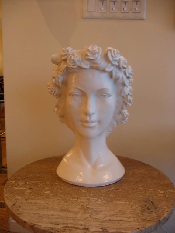 Beautifully sculptural female head with a floral headdress. Serene and pretty face with a large enough opening on top of head for fabulous growing greenery or a floral arrangement. Can also be displayed with nothing but her beauty. Signed  Chrisdon.