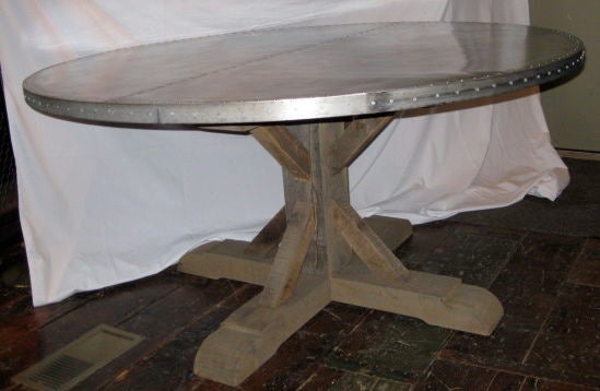 This zinc top dining table is made from 19th century barn wood planks then bleached and waxed. The modern zinc top has a decorative nailhead band and seamed center.
Custom-made.