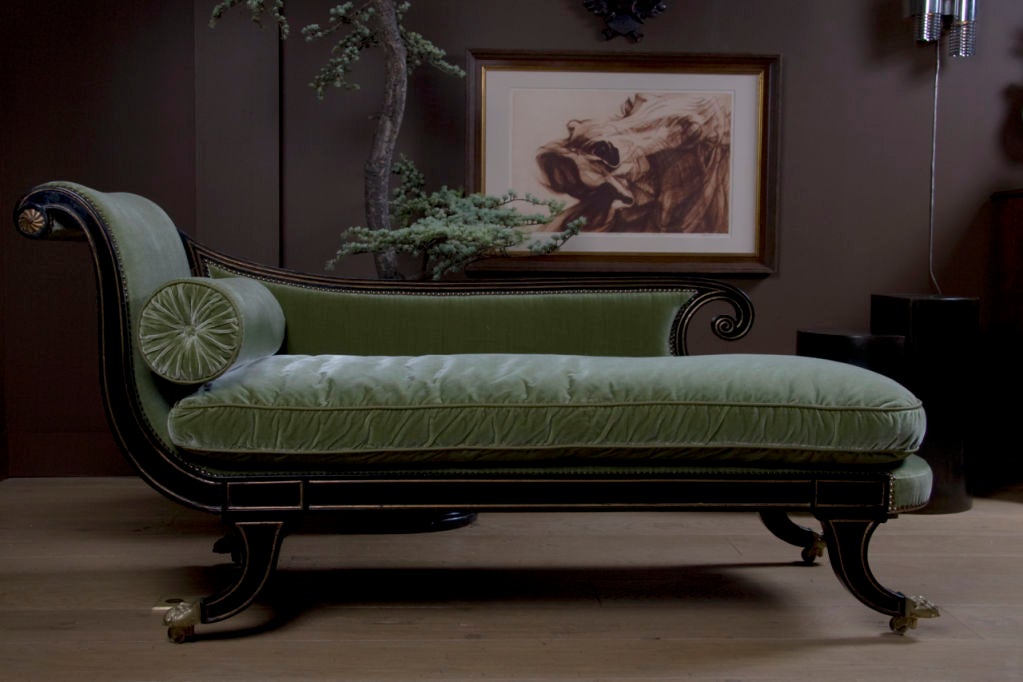With scrolled back rest, the shaped seat raised on sabre legs <br />
terminating in brass animal paw feet on castors; <br />
covered with a beautiful Rosemary Silk Velvet