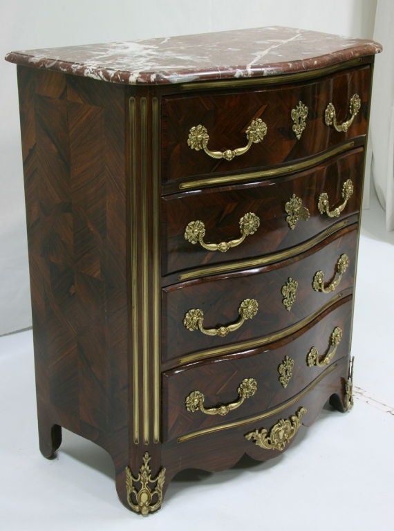 Early 19th century French Regence rosewood marquetry commode with rouge marble (chest of drawers, dresser).
Dimensions: 31'' W x 37'' H x 17'' D.