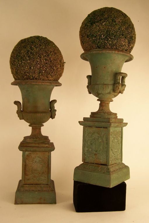 Pair of petite (table-top size) classical-style green-painted cast iron garden urns on plinths. Originally priced at $1500.00