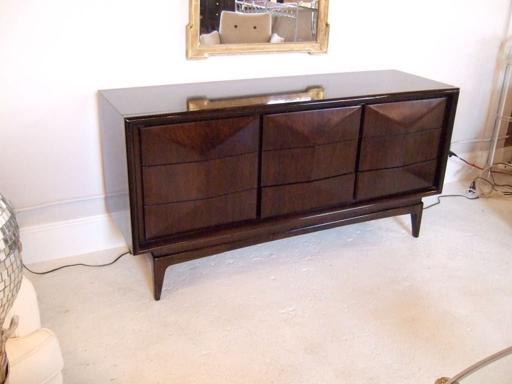 Clean, modern cabinetry with a beveled diamond drawer detail steps up this distinctive Danish dresser.  Handsome dresser with nine hardware-free drawers. Restored finish in chocolate brown. This also makes great sideboard or server.