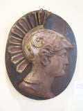 Carved wood medallion depicting a Roman Warrior