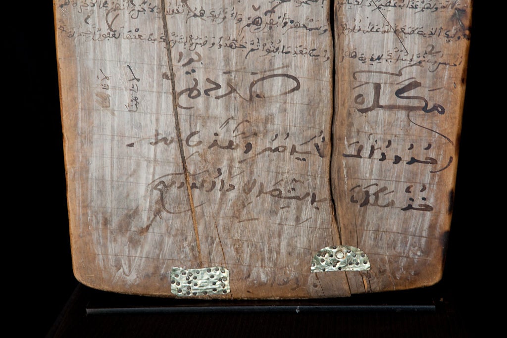 Moroccan marriage contracts executed on cedar wood dating to the early 20th century. Each one comes on a custom-made steel stand, although it is removable so that contract can be hung on the wall.<br />
<br />
We have several in the collection,