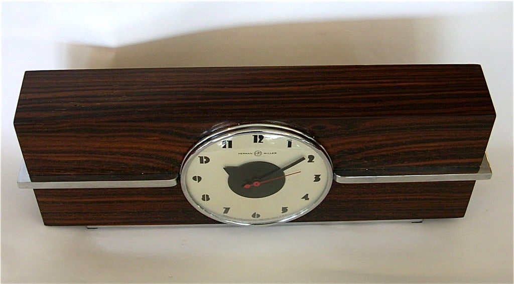 This amazing clock is completely original and in fantastic condition. It is one of the few Rohde designs that is fairly large in size, quite impressive. The clock is a working clock and is quite and accurate. The beautiful rosewood book matched