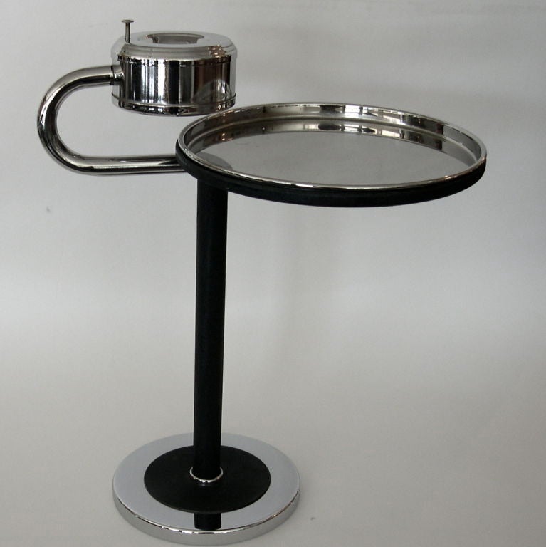 This is one of those great Wolfgang Hoffman pieces that defines coolness. The table top with it's removable tray sits under the ashtray and is able to fully extend via a pivot mechanism just under the table section. The photos show the piece from