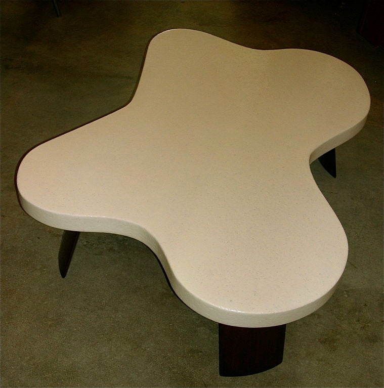 This is an amazing example of an original Paul Frankl amoeba shaped table. It retains it's original cream colored lacquer top. The legs have been waxed and polished. It is gorgeous.