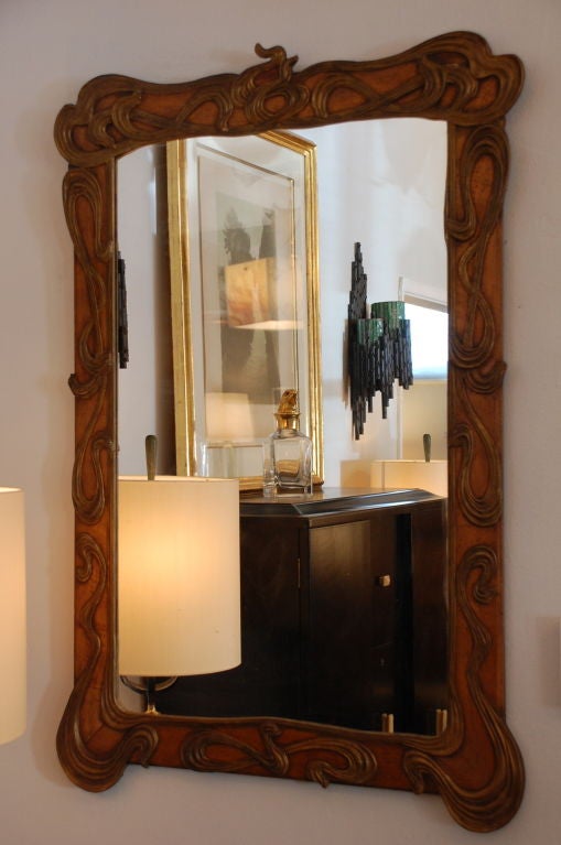 Impressive giltwood Art Nouveau mirror. Beautifully carved frame with partial gilding.