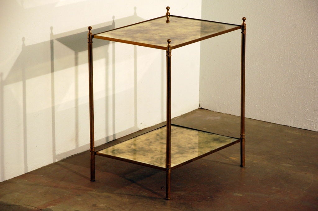 Chic églomisé mirror two tier side table by Maison Baguès. Perfect between a pair of armchairs. Shelves are at 4 in. and 22 in. from the floor.