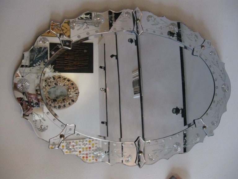 OVAL REVERSE HAND CARVED VENETIAN MIRROR. WITH FLOWERS AND FOLIATE DESIGN.
