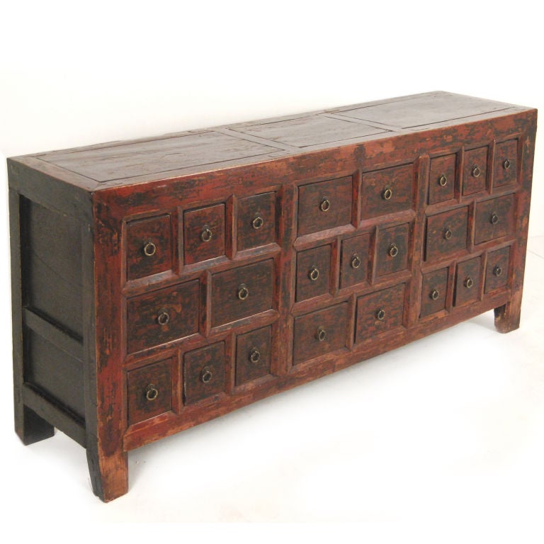 A 19th century Northern Chinese apothecary chest with 23 drawers with brass hardware, and traces of original red lacquer.<br />
<br />
Pagoda Red Collection #:  T089<br />
<br />
<br />
Keywords:  Dresser, chest of drawers, apothecary,
