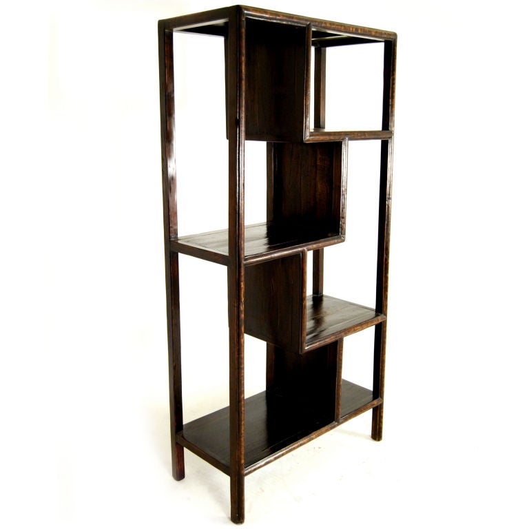 A 19th century Chinese elmwood asymmetrically configured display cabinet with wonderful patina.<br />
<br />
Pagoda Red Collection #:  T104<br />
<br />
<br />
Keywords:  Bookshelf, cabinet, display