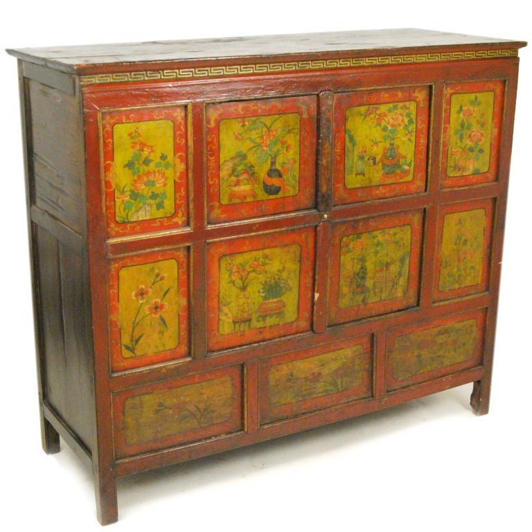 A 19th century Tibetan cabinet with four doors and painted Buddhist symbols and flowers including peonies, lotus and chrysanthemums.<br />
<br />
Pagoda Red Collection #:  BTD009<br />
<br />
<br />
Keywords:  Cabinet, chest, nightstand, bed