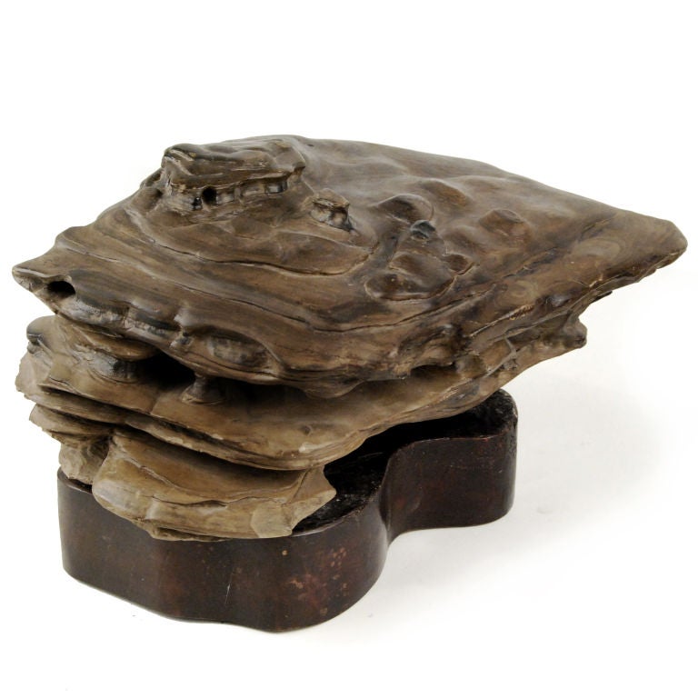 A 19th century Chinese view stone that recalls a mountain landscape with cliffs and caves, mounted on a wooden base.

Pagoda Red Collection #:  P184

Keywords:  Rock, Scholars stone, Chinese, Japanese, Suiseki, sculpture, statue
