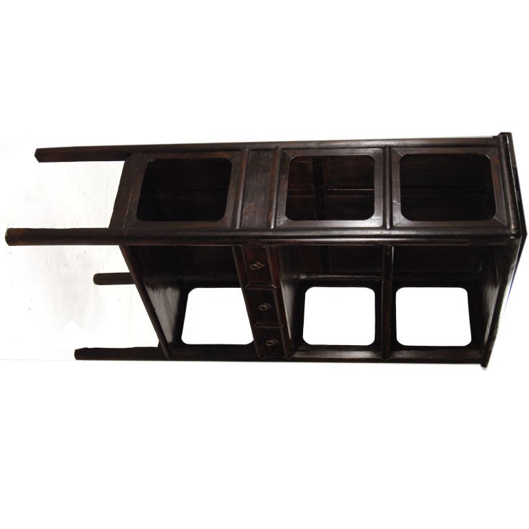 A 19th century Chinese elmwood book cabinet with open sides and three drawers with brass hardware.<br />
<br />
Pagoda Red Collection #:  R097<br />
<br />
<br />
Keywords:  Cabinet, Cupboard, bookcase, book, display, shelf, shelves