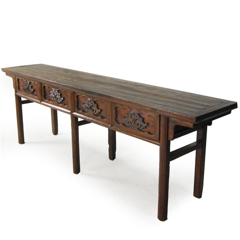 A 19th century provincial Chinese elmwood altar table with four heavily carved drawers depicting vines and auspicious Ruyi.<br />
<br />
Pagoda Red Collection #:  CAF091<br />
<br />
<br />
Keywords:  Table, altar, console, sofa, entry, media,