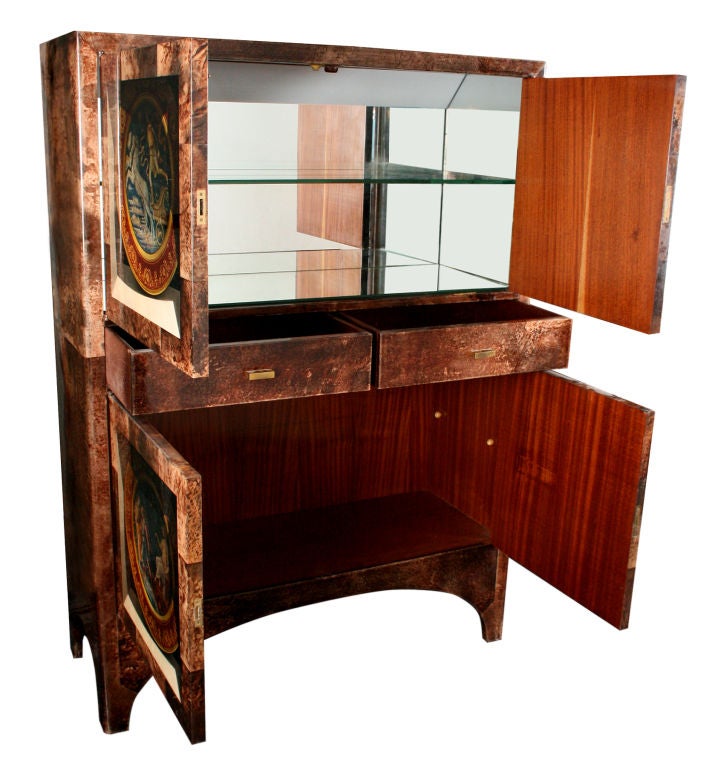 This is by far the best bar cabinet by Aldo Tura. It is exquistely crafted. The upper part has a mirrored interior with one glass shelf. Two drawers seperate it from the lower section which also has room for one glass shelf. It appears that there