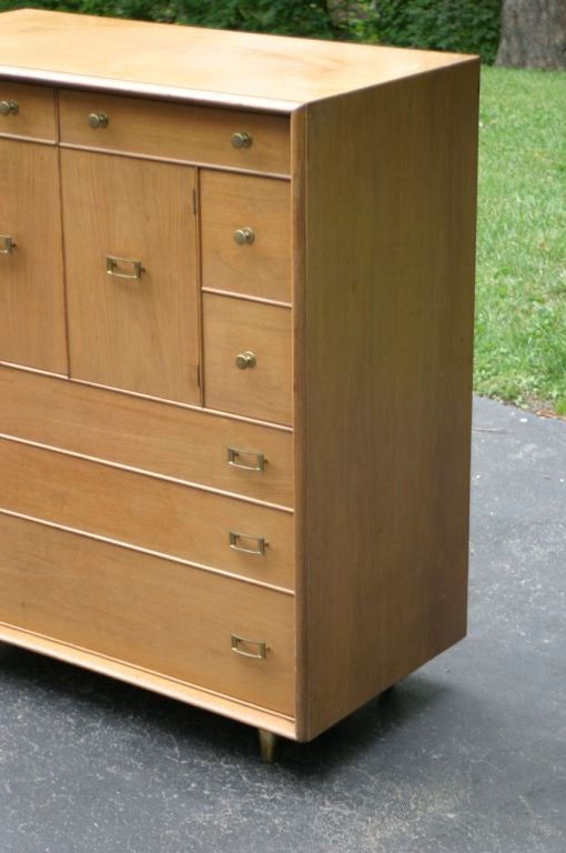 Paul Frankl walnut tall chest with brass hardware and brass conical legs. Price includes refinishing.