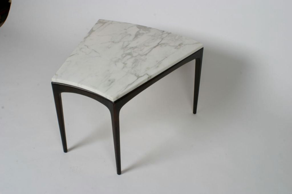Marble top table with mahogany base in wedge shape, tapered legs and slightly concave front. 15