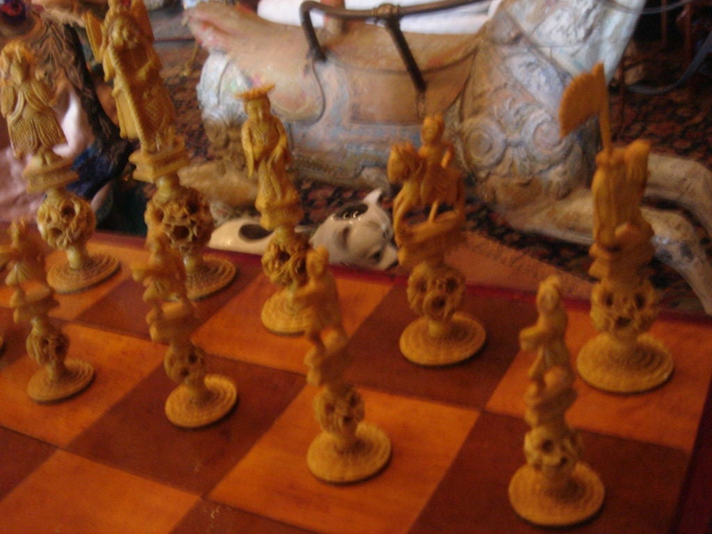 Fabulous ivory chess set completely hand carved with apprentice balls to the main chess pieces (all pieces included and in perfix condition and one-half tea stained the other half of natural color.  Presented in  an oblong brass-mounted parquetry