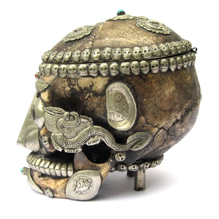 Magnificent human skull clad in silver inset with turquoise and coral . These skulls were used for ceremonial offerings