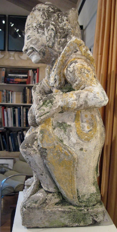 A striking carved stone statue of a Balinese River deity half man / half woman, raising its dress to urinate -- as the source of all rivers