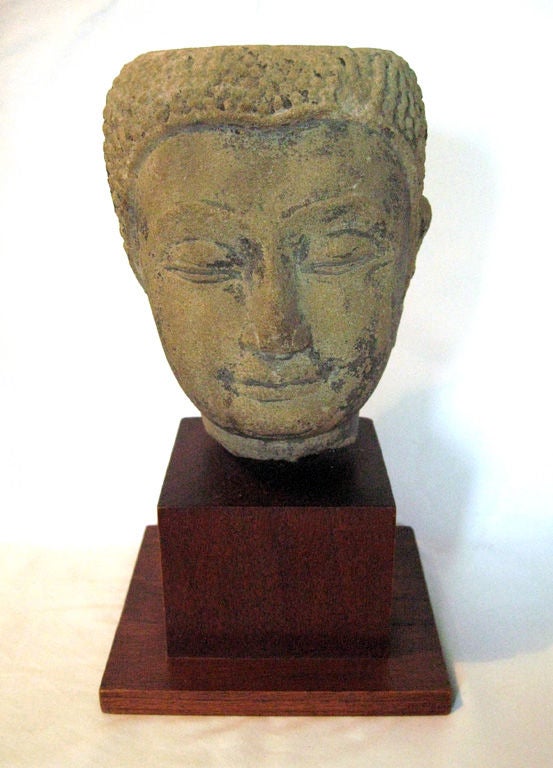 Beautifully serene Buddha head carved out of sandstone with traces of lacquer