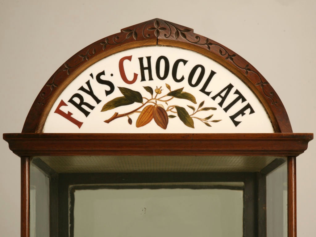 Wonderful original antique English merchant's shoppe fitting. This fantastic cabinet would have originally sat on a shopkeepers store counter, displaying different varieties of Fry's chocolate. A longtime well-known chocolatier, Joseph Fry began