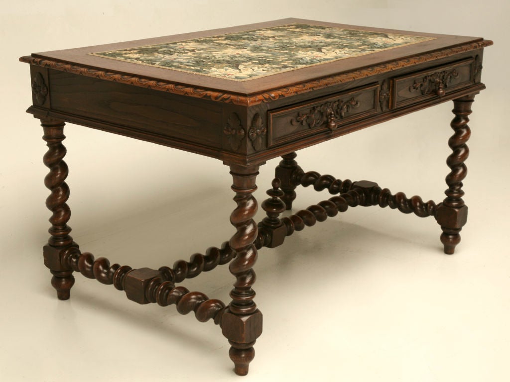 Stunning hand-carved solid French white oak Louis XIII style desk with a beautiful though not original tapestry writing surface. This special desk is in very nice condition for it's age, the barley twist legs and stretcher give this desk plenty of