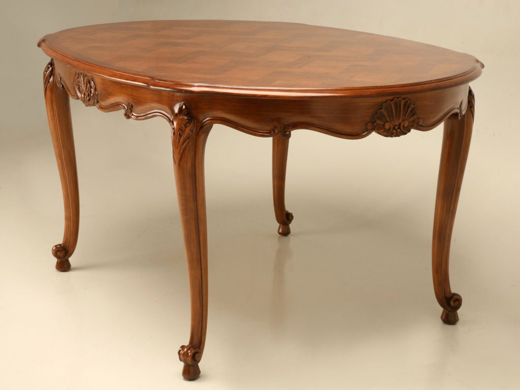 Gorgeous vintage French cherrywood Louis XV style oval dining table. What a statement this table makes with it's graceful cabriolet legs, carved and scalloped apron, and magnificent parquet top, too. Although it apparently had leaves at one time,