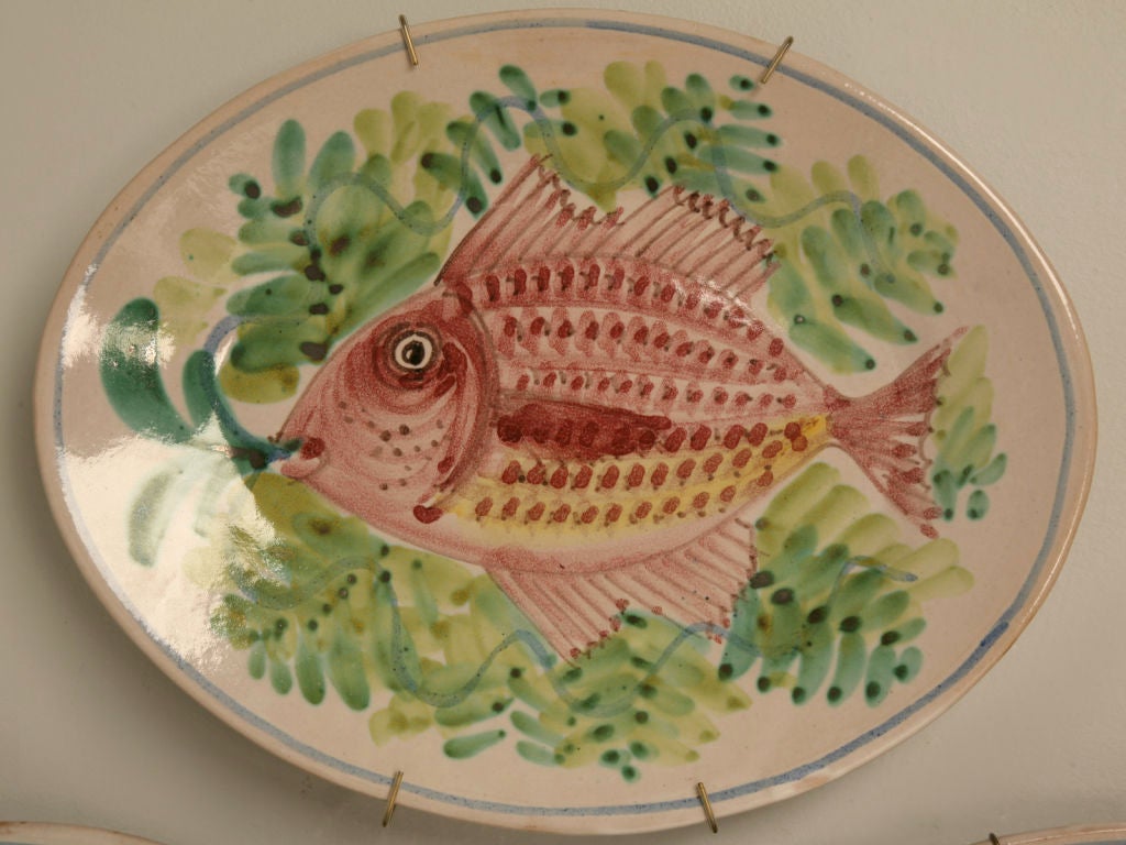 Outrageous set of 4 vintage Italian hand-painted fish platters. Awesome utilized as a wall grouping or as serving platters at a party. Each of the four are different, though sold as a set.
