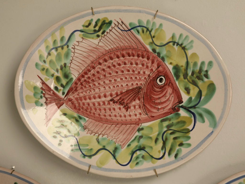 Outstanding set of 4 vintage Italian hand-painted oval fish platters. Striking hung as a grouping on the wall, or as serving platters at a party. Either way these fish platters are a unique collection. Sold as a set, each one is different.