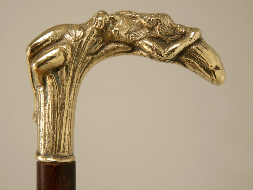 Wonderful antique French Art Nouveau gentleman's walking stick with a reclined woman cast in bronze for the handle. Whether utilized for everyday use, or to add to your collection, this is a beauty.