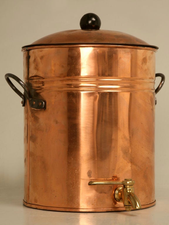 This would make a great kitchen decoration! Vintage brass and copper beverage dispenser with a spigot that we think was intended for commercial use in a restaurant. The diameter below is with the spigot and handles included. It measures 11