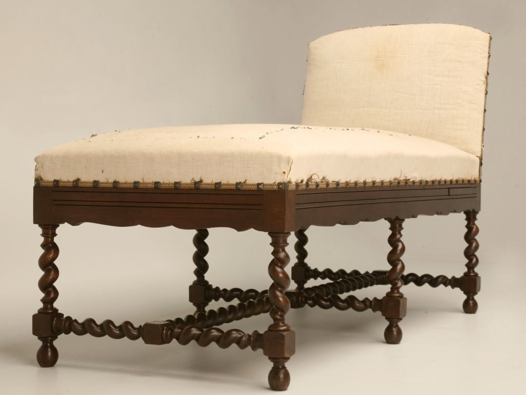 Exquisite antique French Louis XIII chaise with a scalloped apron and dynamite barley twist legs and cross-stretcher. A wonderful generous size makes this particular chaise not only beautiful to look at, but it's extremely comfortable too.