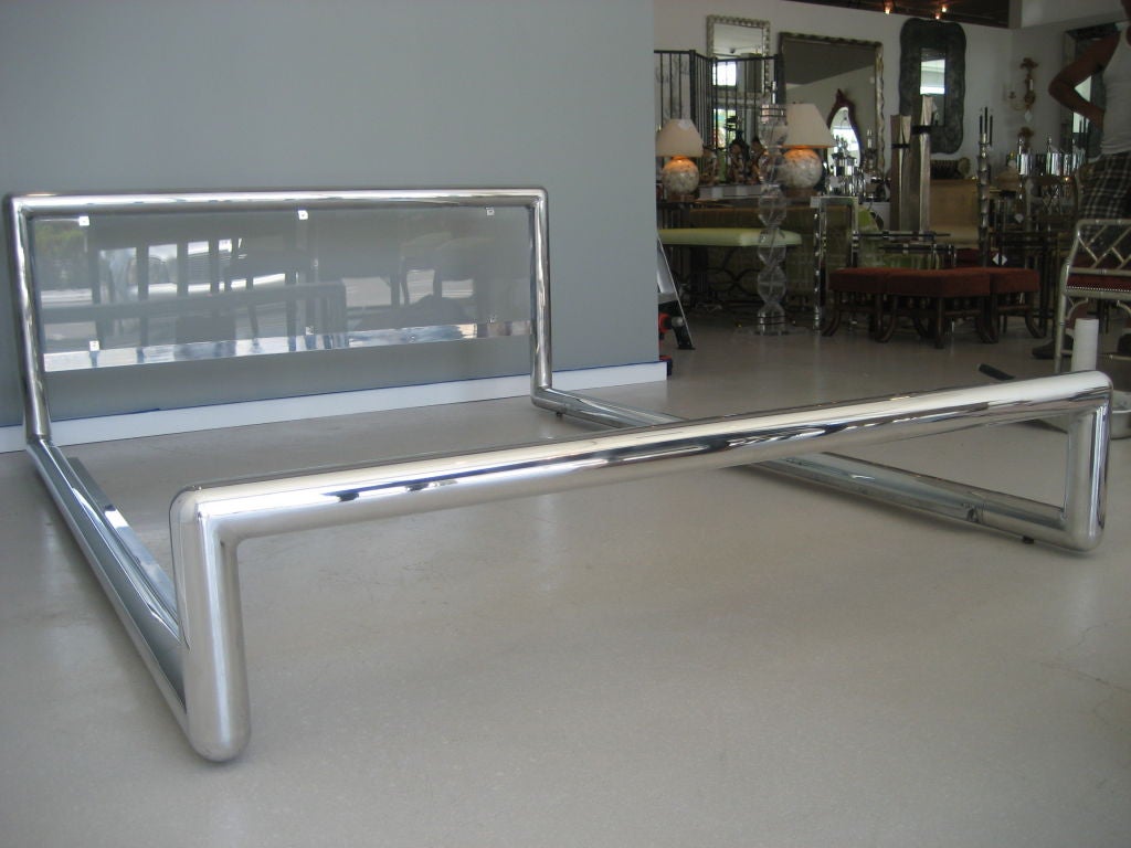 Dynamic chrome and lucite tubular bed. The bed is queen size and low to the ground. It is a well designed bed- made to look like a continuous tubular drawing in space.