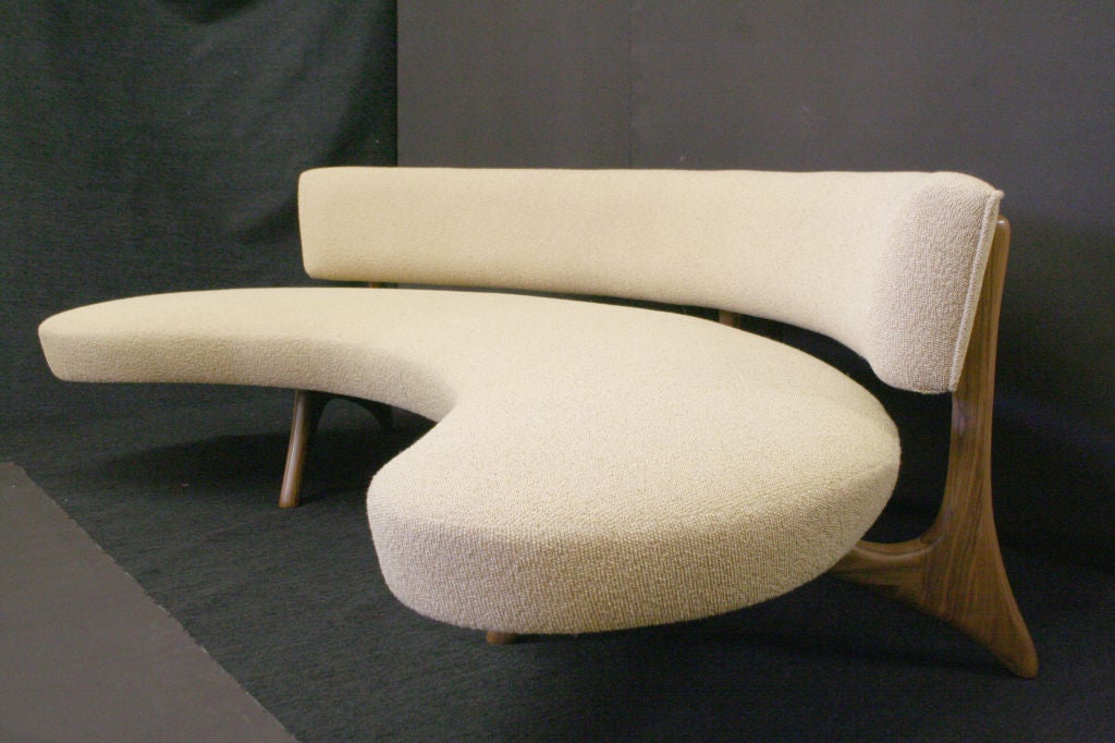 A biomorphic sofa in the manner of Vladimir Kagan with curved backrest and a floating platform seat set on sculptural carved legs which blend seamlessly into the support for the back. <br />
You can have it in any fabric you choose.