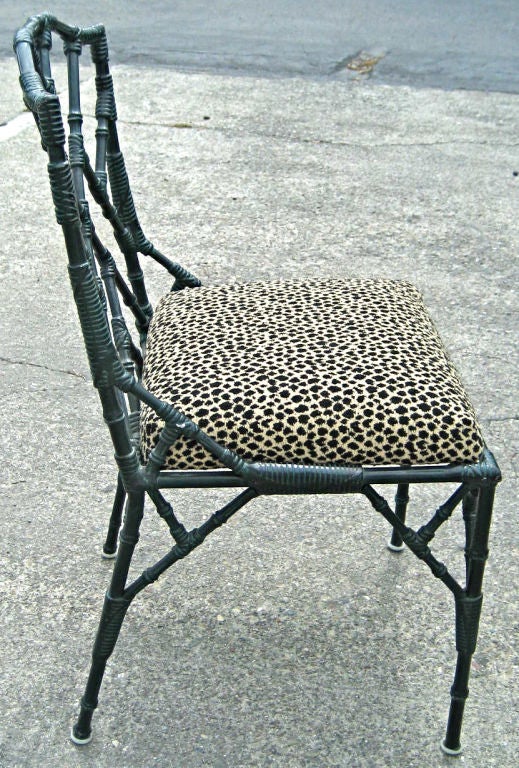 Set of four faux Bamboo side chairs in cast Aluminum by Veneman. The set has beautifully cast details with simulated bound joinery. Freshly upholstered in Kravet Soleil Outdoor Chenille Leopard print.