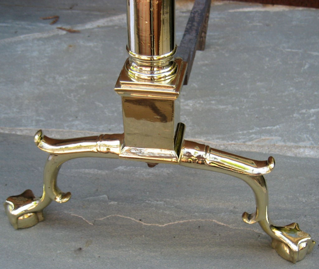 Pair of Brass Column on Plinth Andirons with Urn finials and ball and claw feet.