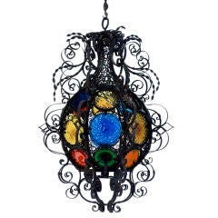 An Italian Wrought and Filigree Iron and Colored Glass Lantern