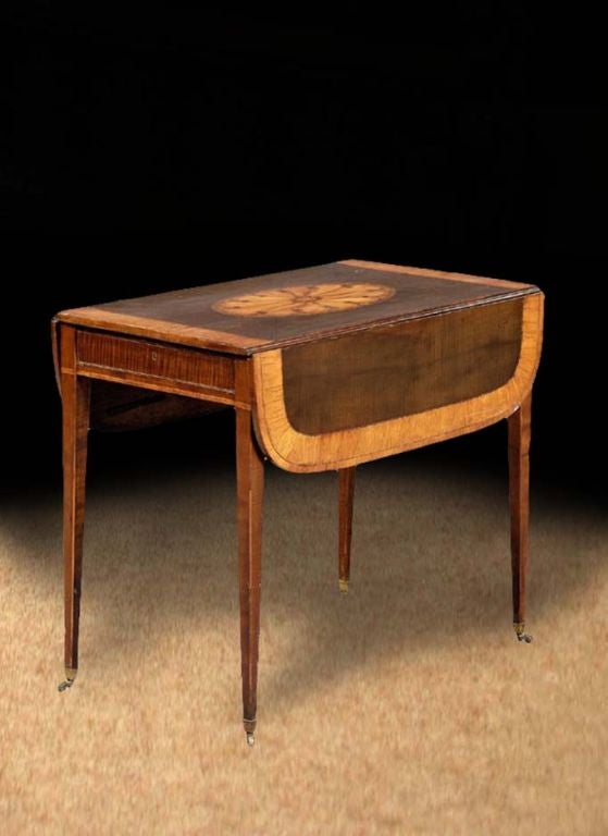 # T095 - George III rectangular Pembroke table (named after the Earl of Pembroke who reputedly ordered the first one) admirably executed in beautifully grained mahogany and enriched with inlays. The top with a wide crossbanded border all around