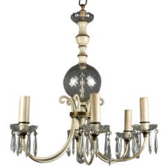 An antique brass chandelier dressed with prisms
