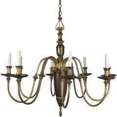 An antique eight light brass chandelier