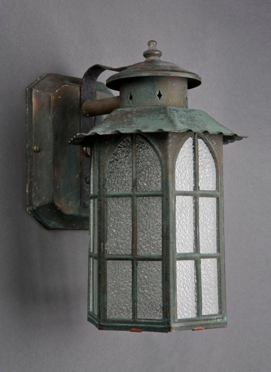 An antique pair of verdigris exterior wall lanterns