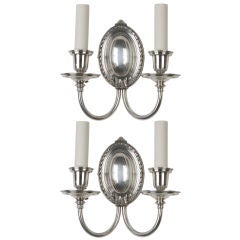 A pair of two arm silver sconces by Bradley and Hubbard
